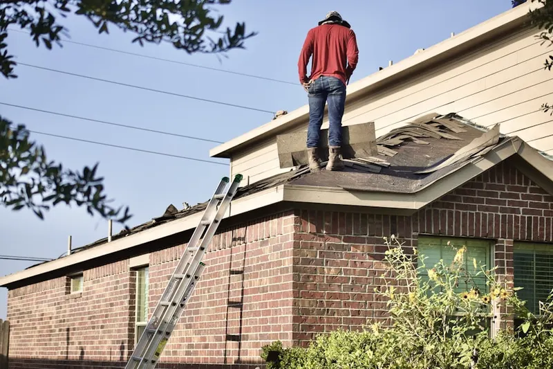 Professional roofer working on a residential roof in Irving